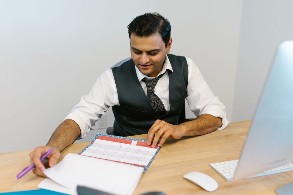 Borrower checking a calendar while tracking a loan application